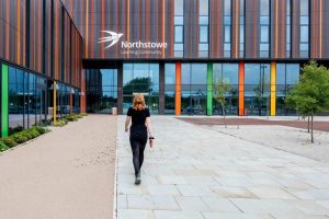 Woman walking towards modern building