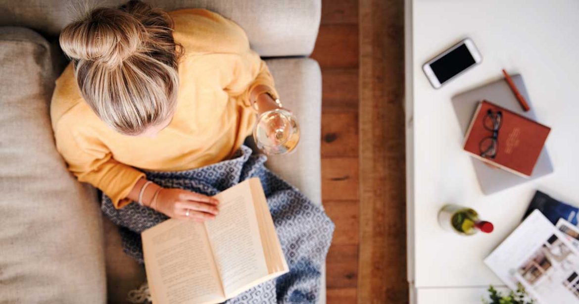 Edition Book Club - woman reading on sofa