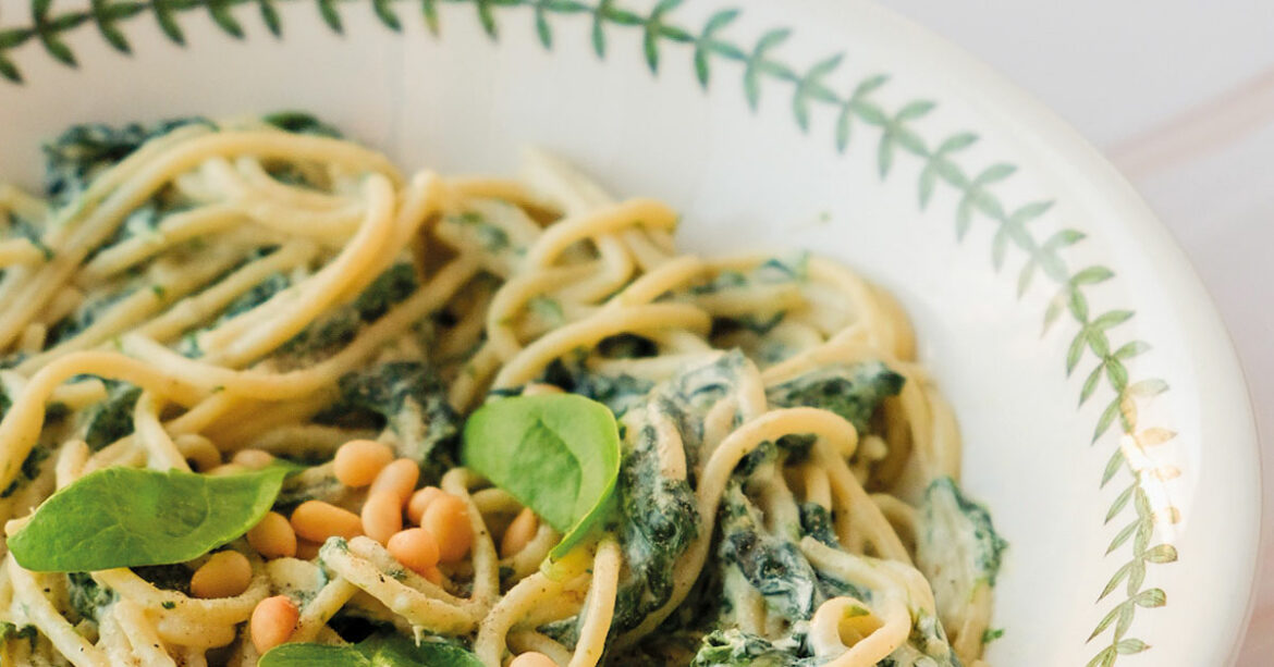 Bowl of spaghetti, spinach and ricotta, plus pinenuts